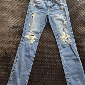 The American Eagle Slim Straight Blue Distressed Denim Jeans are a stylish and c